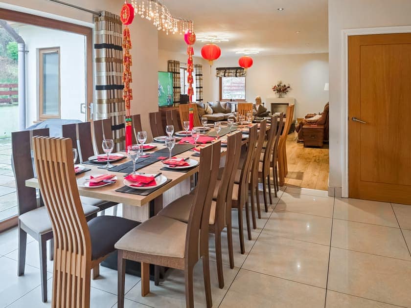 Dining table extends to seat up to 18 guests | Wernddu Fechan House - Wernddu Properties, Neath
