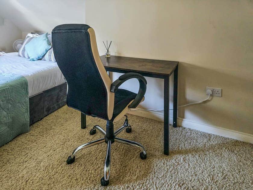 A spacious triple bedroom with king bed, single bed. Work space and ensuite bathroom  | Wernddu Fechan House - Wernddu Properties, Neath