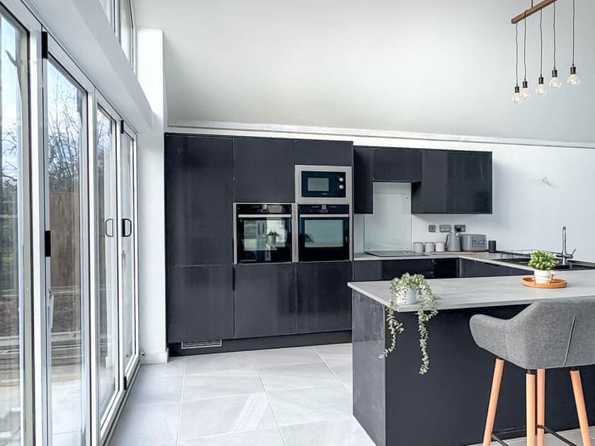 Brand new modern kitchen and breakfast bar set in the large open plan Kitchen, dining, living room,  incorporating twin Neff ovens,  Hob, dishwasher and Washing machine. | Seafields, Sidestrand