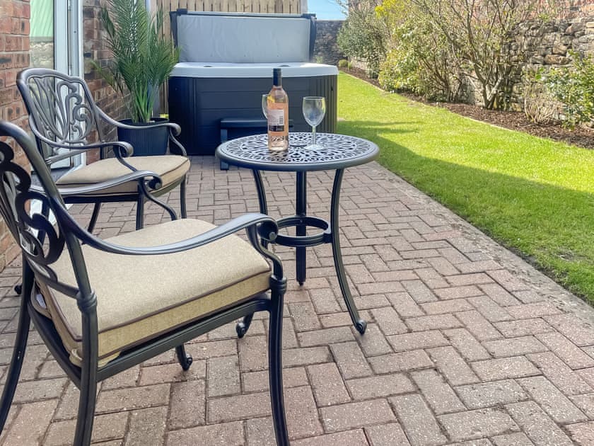 Sitting-out-area | Milking Parlour - Dickinson Place Holiday Cottages, Allonby