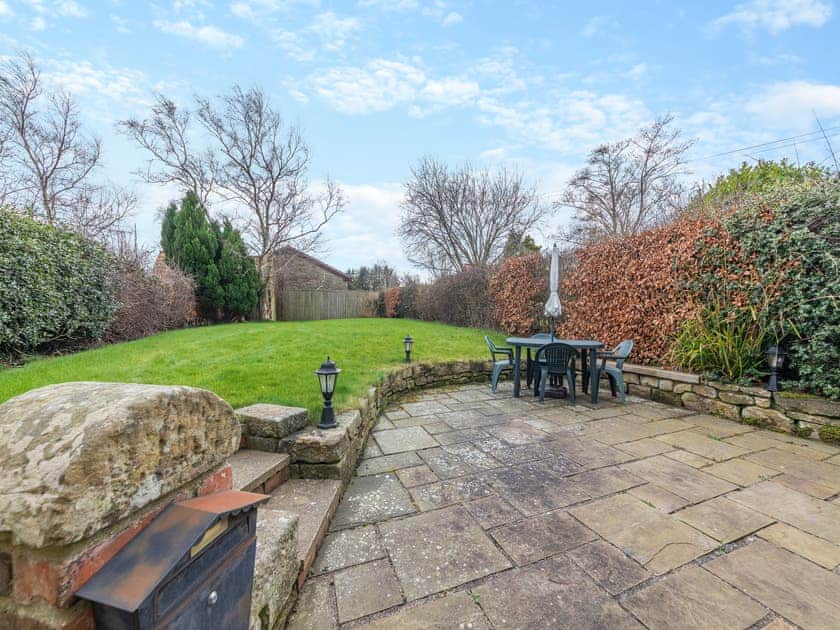 Garden showing large patio | Bumble Cottage, Newton-on-the-Moor, near Alnwick