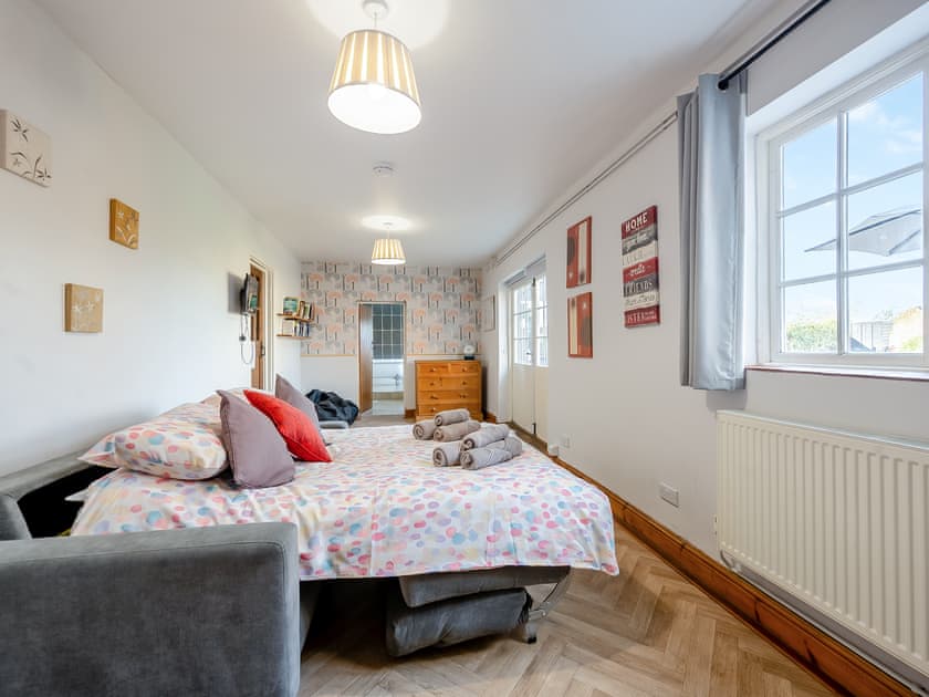 Garden room with pull-out sofa  | Middle Farm, East Harling, near Thetford