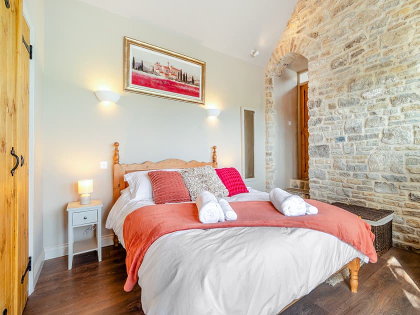 Master bedroom with en-suite 17th century stone wall and beems | Stone Cottage, Wedmore, near Glastonbury