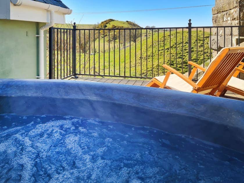 Relax in the hot tub while enjoying the beautiful view | The Railway Sleeper, Sandilands, near Lanark