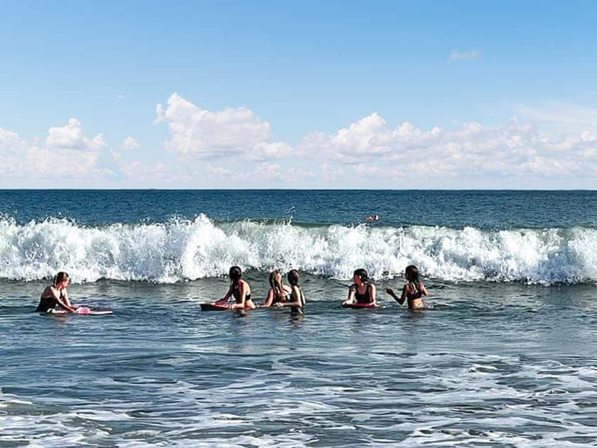 Catching the waves at Port Eynon Beach  | Bungalow Highfields, Port Eynon