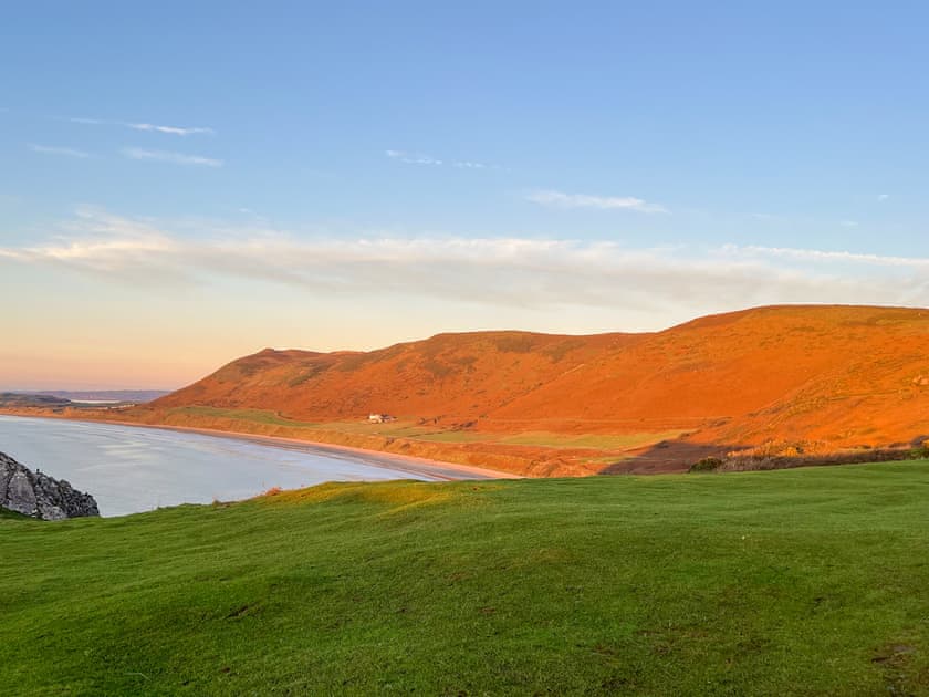 View of Rhossilli Beach and the mountain covered in heather, taken from the Vile at Worms Head a National Trust  | Bungalow Highfields, Port Eynon