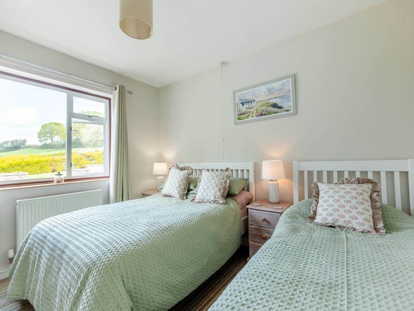 Twin bedroom with one double bed and one single bed  | Osmore Orchard, Membury