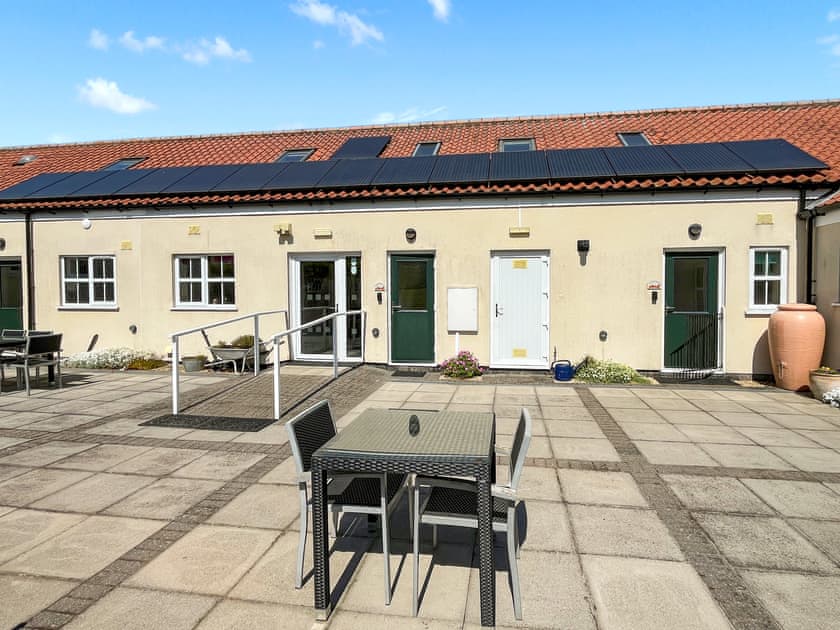 Courtyard patio area with table & chairs plus front door to Lauras Loft  | Lauras Loft - Greetham Retreat, Greetham, near Horncastle