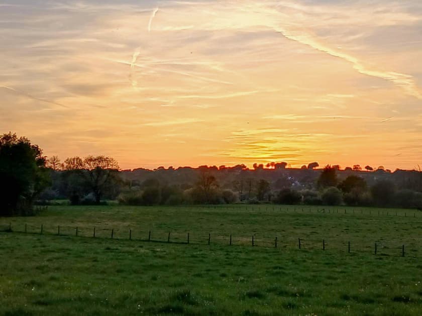 Sunset view from seating area. | Rosie - Tanyrallt Holidays Lets, Llanybydder, near Lampeter