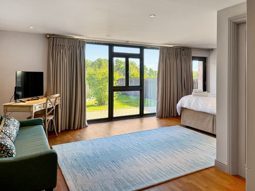 Seating area in bedroom one and view outside | Barn Owl Cottage - Home Farm Retreats, Kirk Hammerton, near York