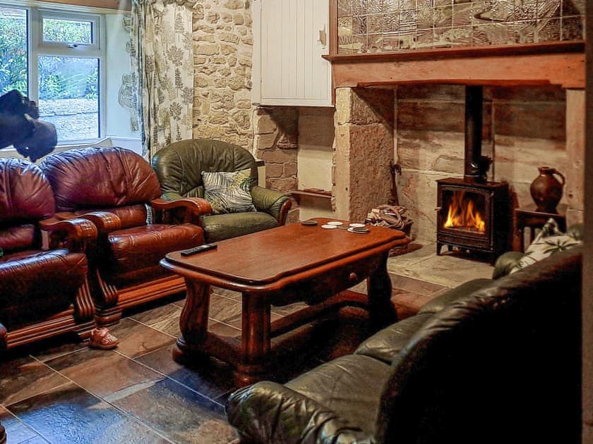 Inglenook hamstone fireplace with wood burning stove. Above the fireplace is a handmade mural made by David Eeles. | Brockhill House, Beaminster
