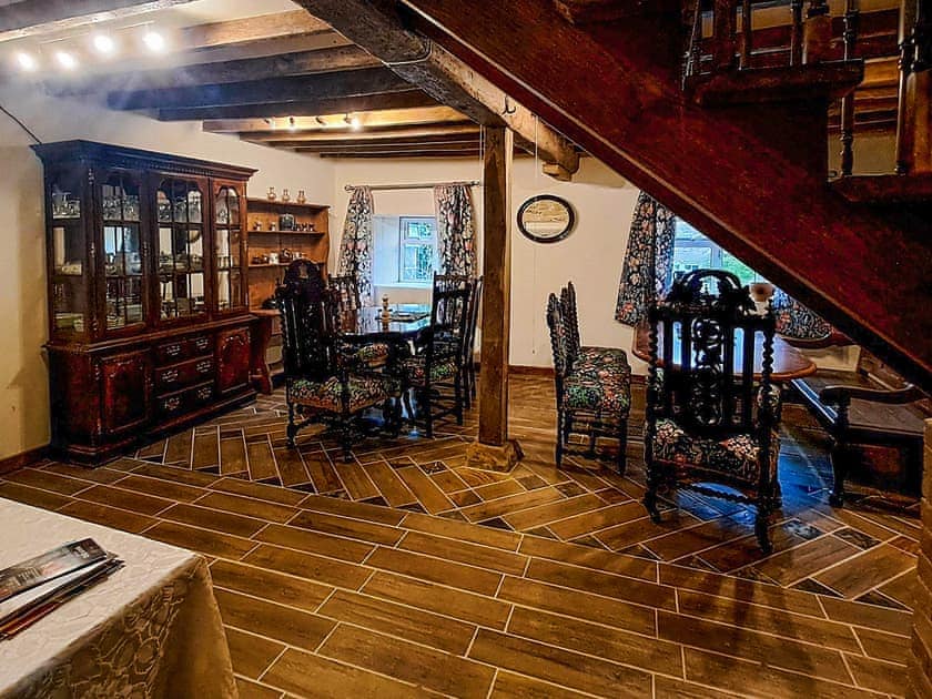 Dinning room with tiled floor. Two tables and seating for sixteen. | Brockhill House, Beaminster