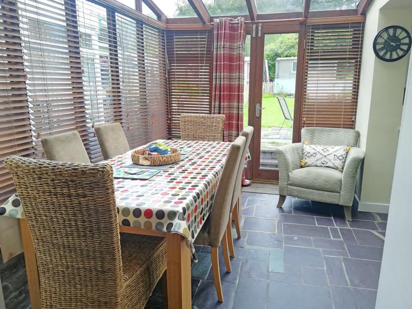 Dining area with double doors opening to the garden/patio area | Maes Derlwyn, Llanberis, near Caernarfon