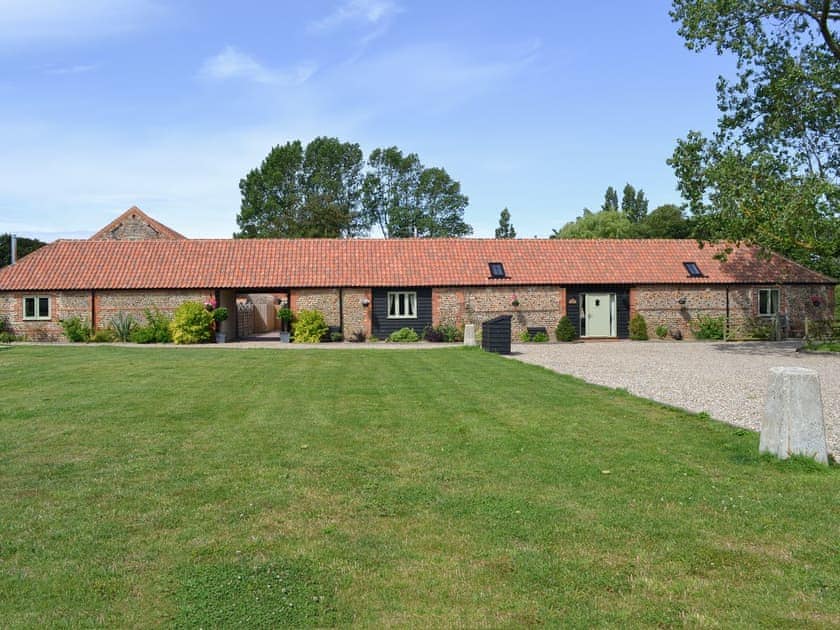 Exterior, traditional Norfolk brick and flint barns, with large lawned garden | Manor Farm Barns, Witton, nr. North Walsham