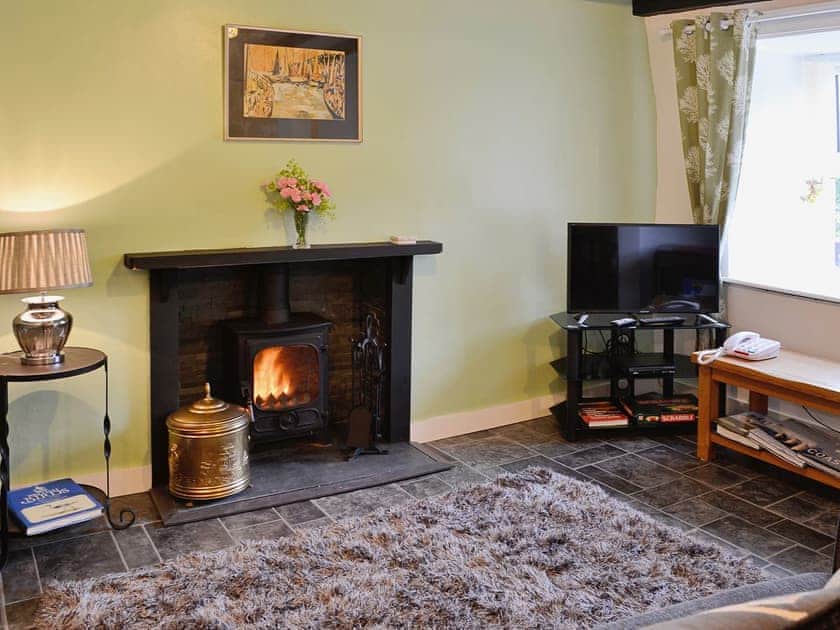 Living/Dining room with open fireplace and woodburner | Capel Fawnog Mawr - Capel Fawnog Mawr and Capel Fawnog Bach, Talsarnau near Harlech