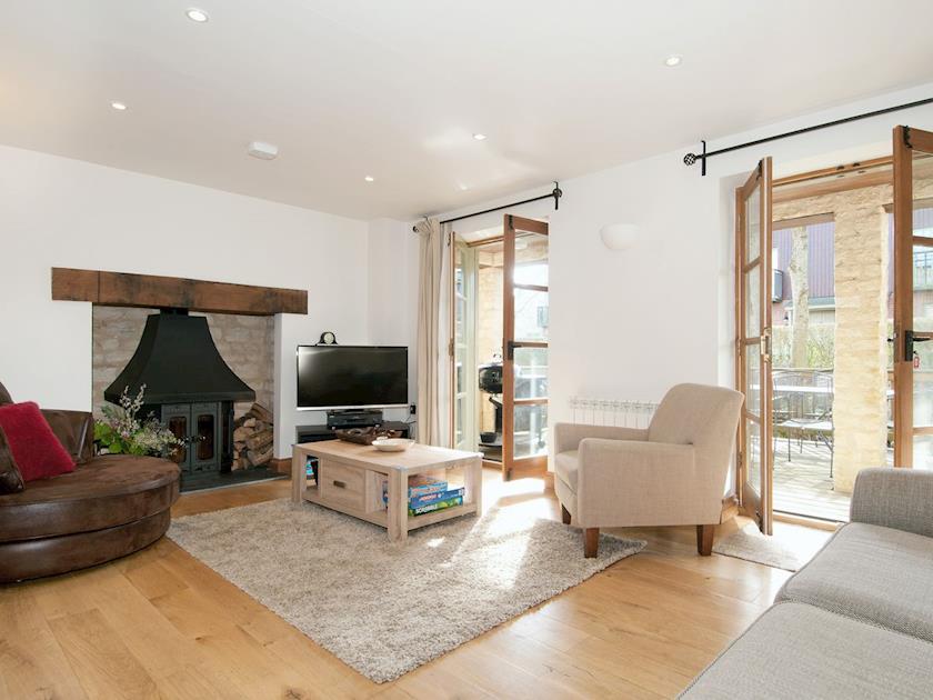 Open-plan living/dining room with wood-burning stove | Juniper House, Cirencester