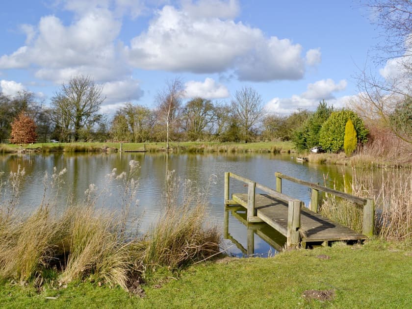 Well-stocked fishing lake within grounds | Apartment 2 - Glebe Farm Apartments and Lodge, West Barkwith, near Market Rasen