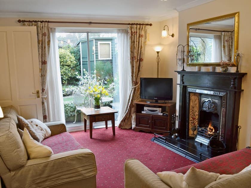 Living room with open fire and patio doors | Lace Cottage, Ashbourne