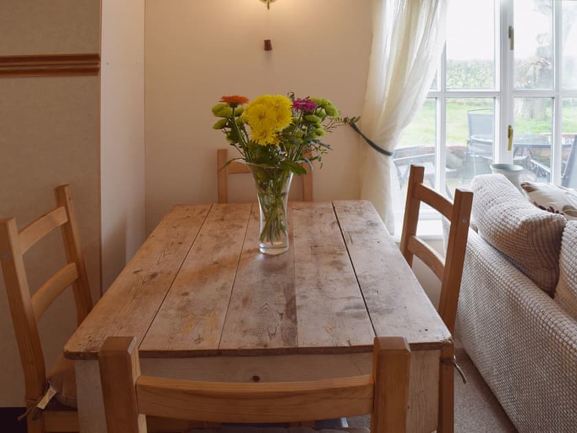 A farmhouse kitchen style dining table between the living and kitchen area has great views over the countryside | Blueberry Cottage, Debenham, near Framlingham