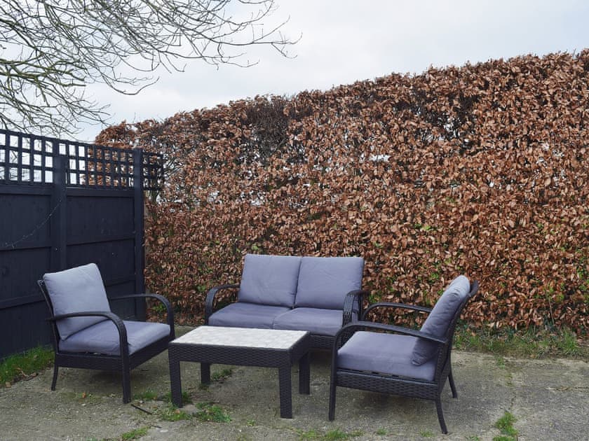 The additional seating on the patio makes an ideal space to relax with a good book | Blueberry Cottage, Debenham, near Framlingham