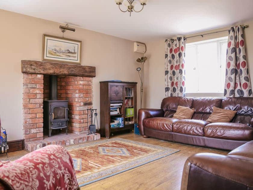 Spacious living room with wood burning stove | Miller’s House - Millmoor Farm, Bickley, near Malpas