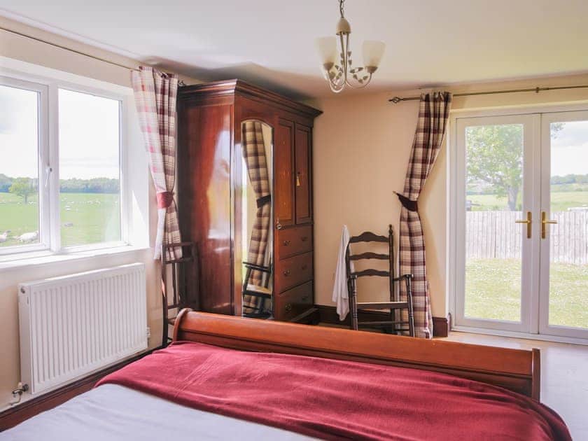 The master bedroom commands panoramic rural views and French door access to the garden  | Miller’s House - Millmoor Farm, Bickley, near Malpas