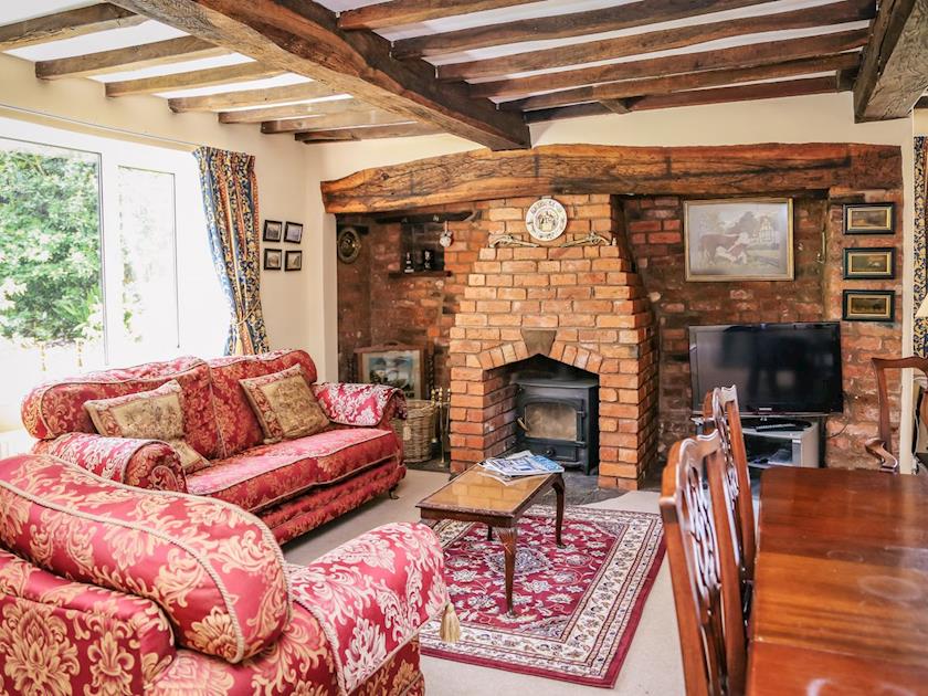 Heritage features abound in this beautiful living/dining room | Farmhouse Wing - Millmoor Farm, Bickley, near Malpas 