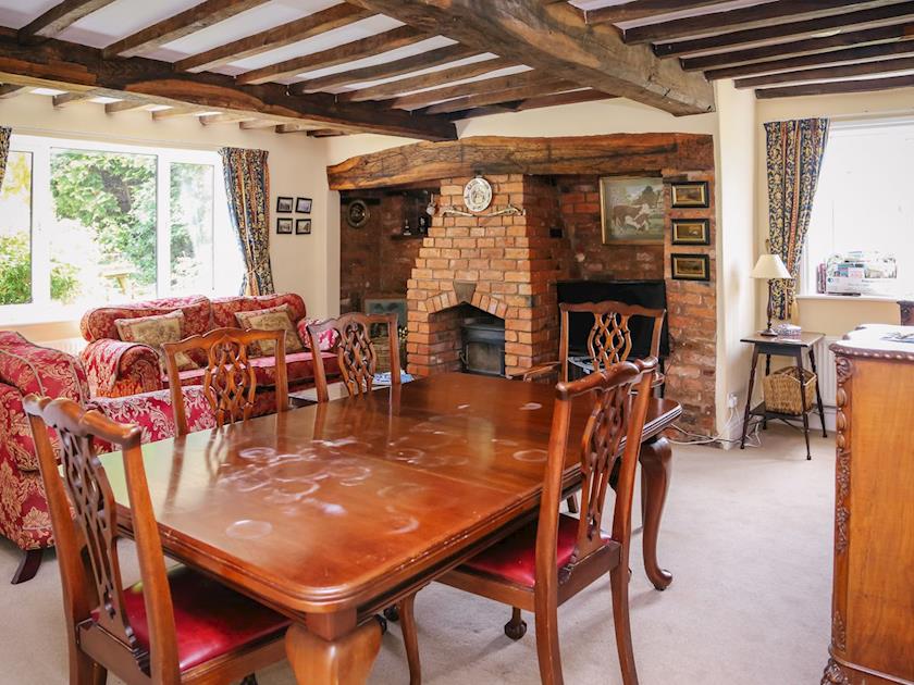 Stunning wooden-beamed ceiling and feature fireplace in spacious living and dining room | Farmhouse Wing - Millmoor Farm, Bickley, near Malpas 