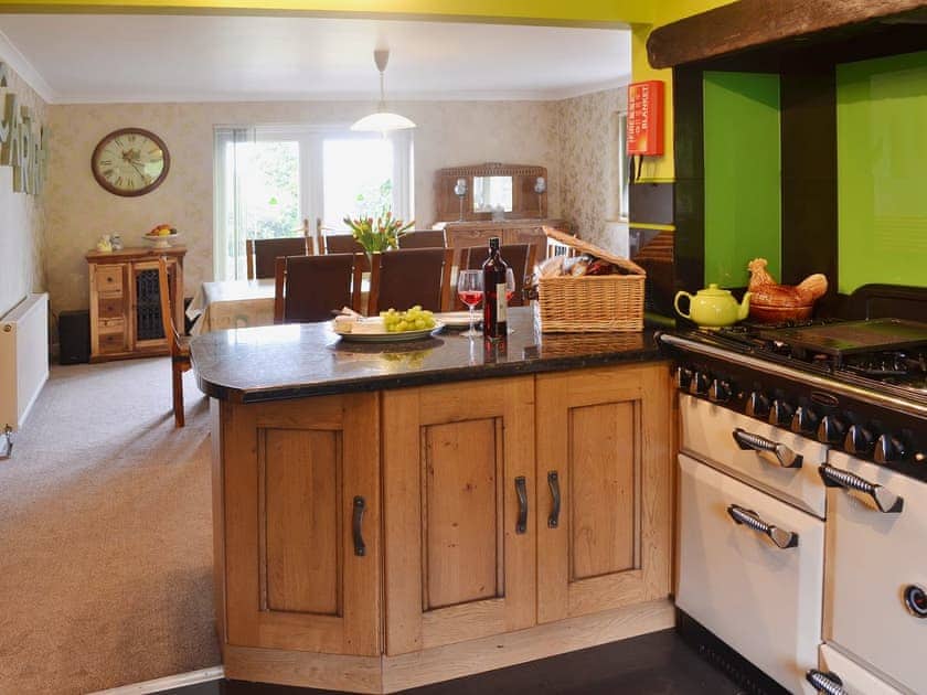 A granite-topped breakfast bar offers a convenient spot for ’meals on the go’ | Carreg Y Garth Isaf, Rhiwlas near Bangor