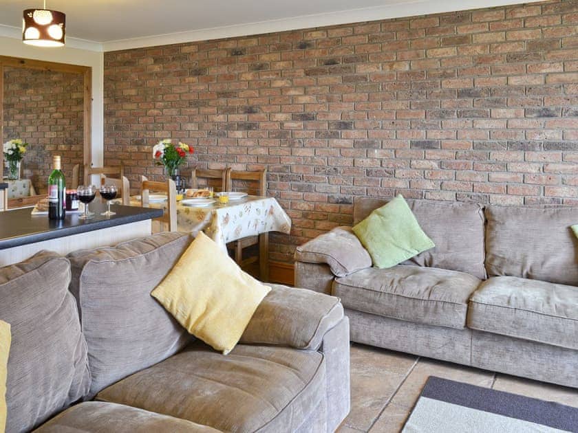 Attractive lounge area of open-plan room | Bevan Cottage - Filey Holiday Cottages, Filey