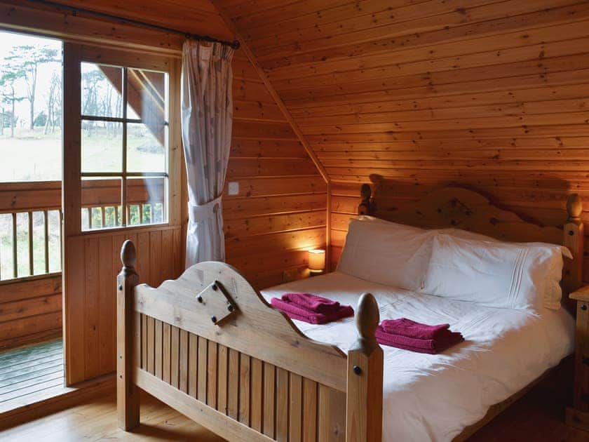 Double bedroom with french doors and en-suite shower room | Sun Rise Lodge, Llanbedr