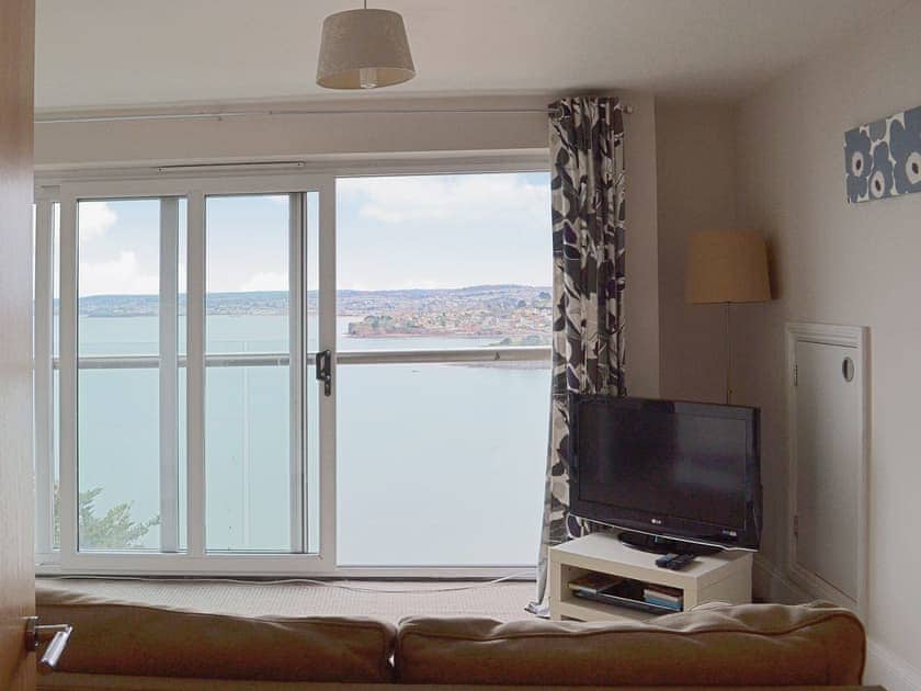 The living rom has patio doors opening onto a balcony with far reaching views | Apartment 16 - Astor House, Torquay