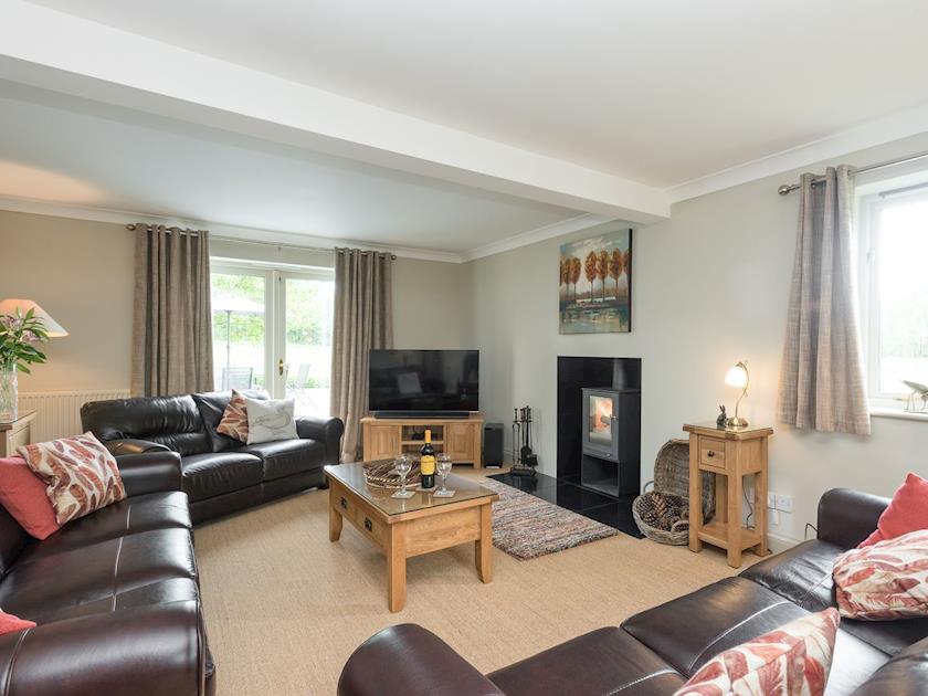 Spacious living room with wood-burning stove | Burgess House, Caston, near Attleborough