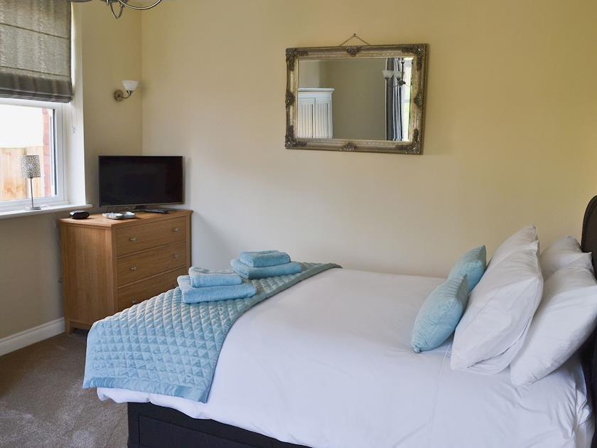 Double bedroom with 5ft bed, TV and seating area | Birchfield, Rhuallt, near St Asaph