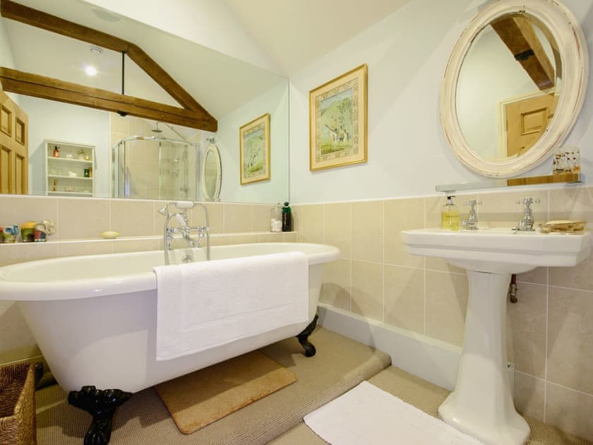Bathroom with roll-top bath | The Stables, Weedon, near Daventry