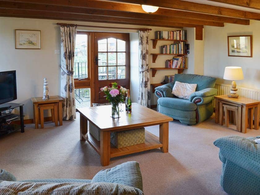 The spacious lounge is furnished comfortably | Coachmans Cottage, White Cross, near Newquay