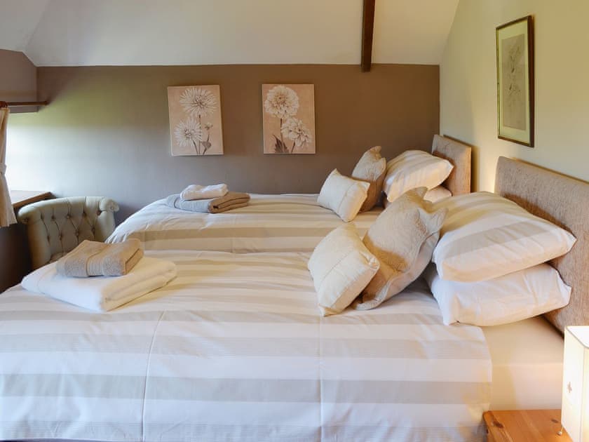 Whilst having sloping ceilings the double bedroom is spacious | Coachmans Cottage, White Cross, near Newquay