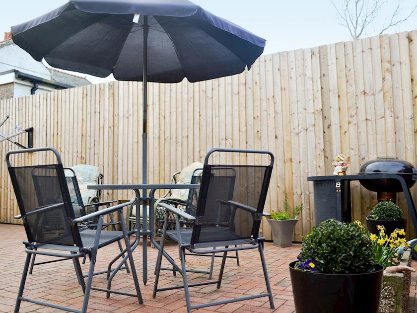 Sitting out area on the patio | The Snug, Caergeiliog, near Holyhead