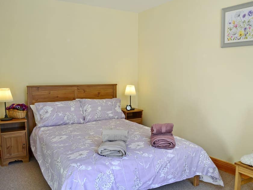 Comfortable double bedroom with king size bed  | Waulkmill Cottage, Carronbridge near Thornhill