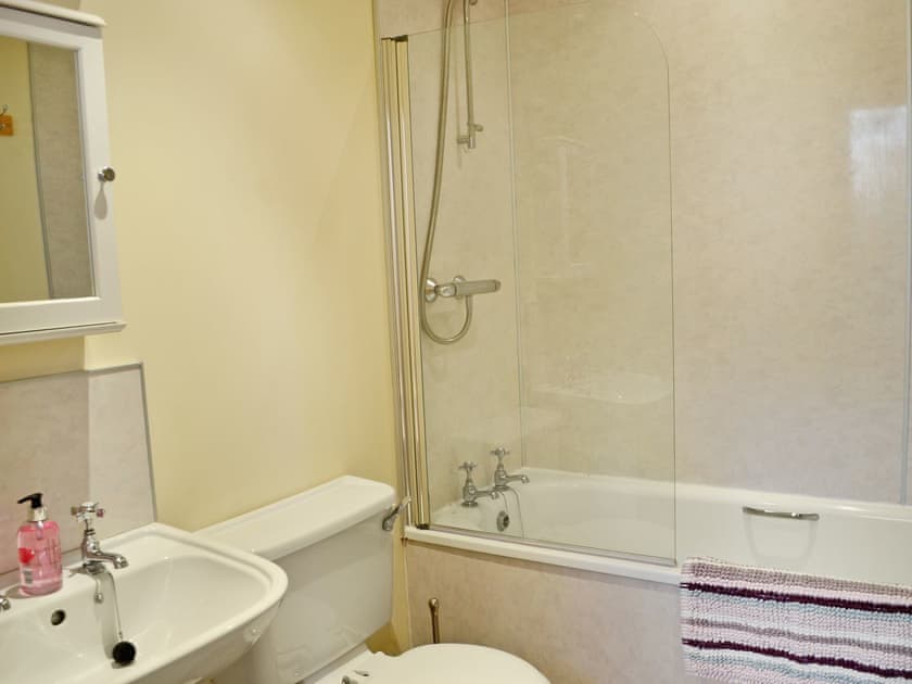 Bathroom with shower over bath and WC | Waulkmill Cottage, Carronbridge near Thornhill