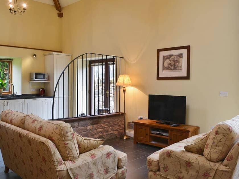 Large lounge area with 38 inch Freeview TV, DVD player and patio doors. | Mere Croft, Sowerby Row near Penrith