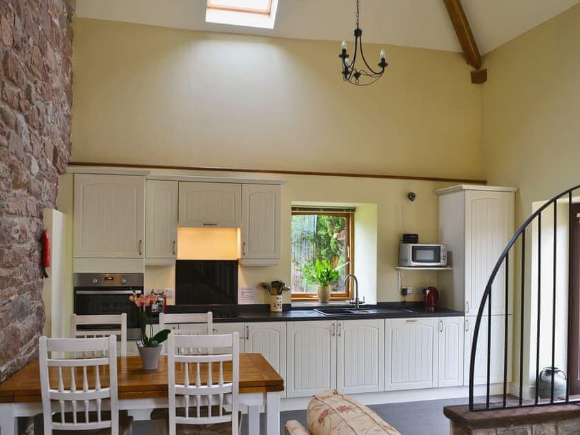 Galley-style kitchen area  with electric oven, ceramic hob, microwave, fridge/freezer and dishwasher. | Mere Croft, Sowerby Row near Penrith