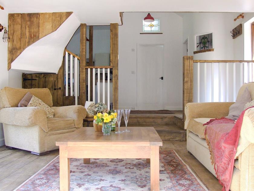 Living room with beams, wooden floor and French doors | Brook Lodge - Dartmoor Lodges, Doccombe, near Dunsford