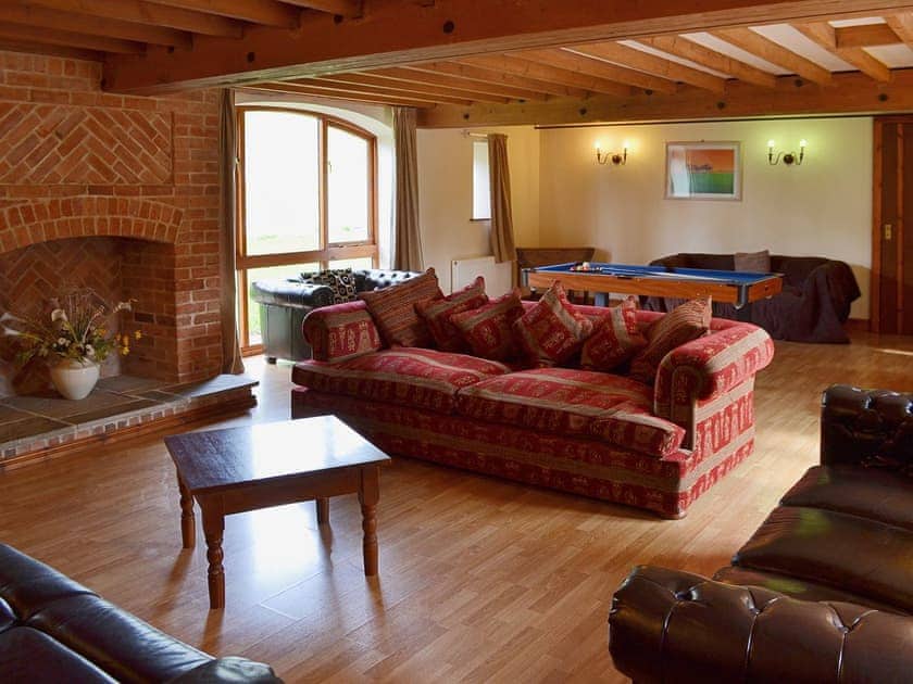 The large beamed living room with comfortable leather sofas | The Granary, Somersal Herbert, Ashbourne