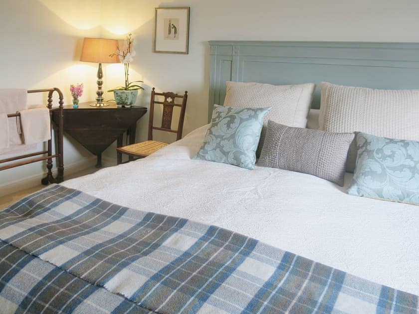 The double bedroom has luxurious bed linen and cosy, romantic furnishings | The Coach House - Berrington House, Tenbury Wells