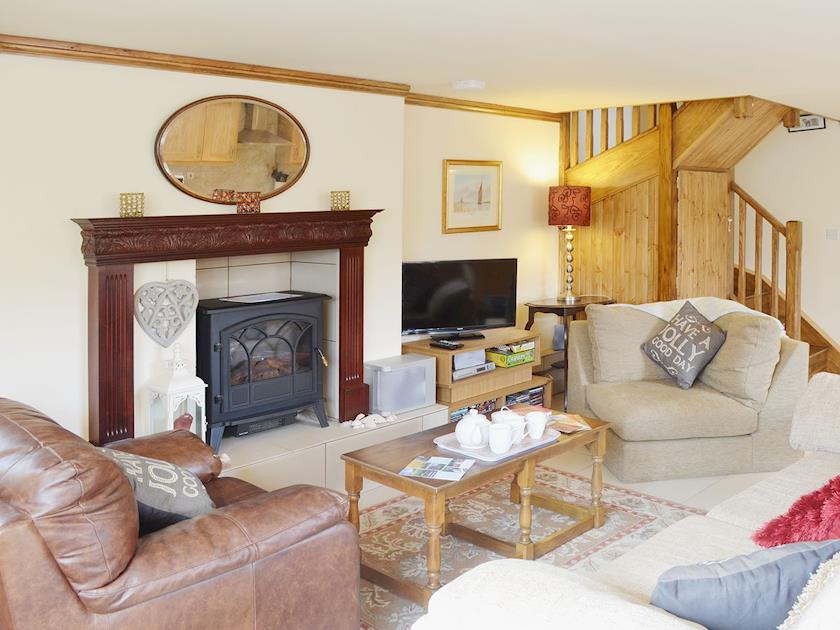 Spacious living area with feature fireplace and electric woodburner | Yr Wyddfa - The Old School, Caeathro, Caernarfon