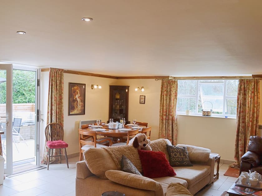 The open plan living area opens up onto the patio making the room bright and airy | Yr Wyddfa - The Old School, Caeathro, Caernarfon