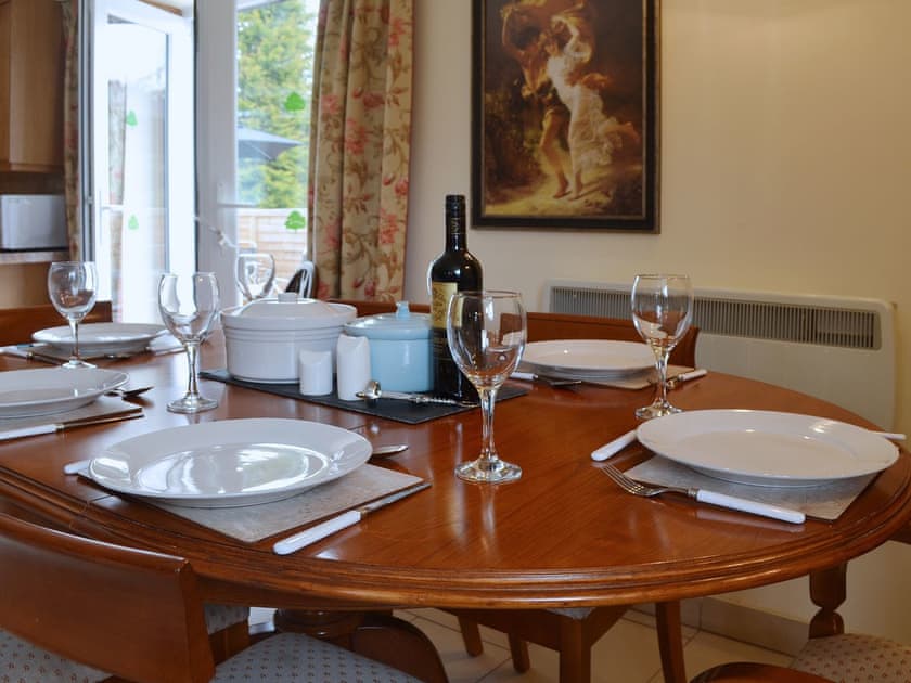 An oval dining table gives a formal air to mealtimes | Yr Wyddfa - The Old School, Caeathro, Caernarfon