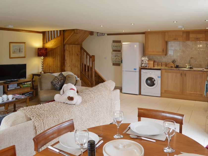 Access to the first floor is via the twisting feature staircase in the open plan living area | Yr Wyddfa - The Old School, Caeathro, Caernarfon