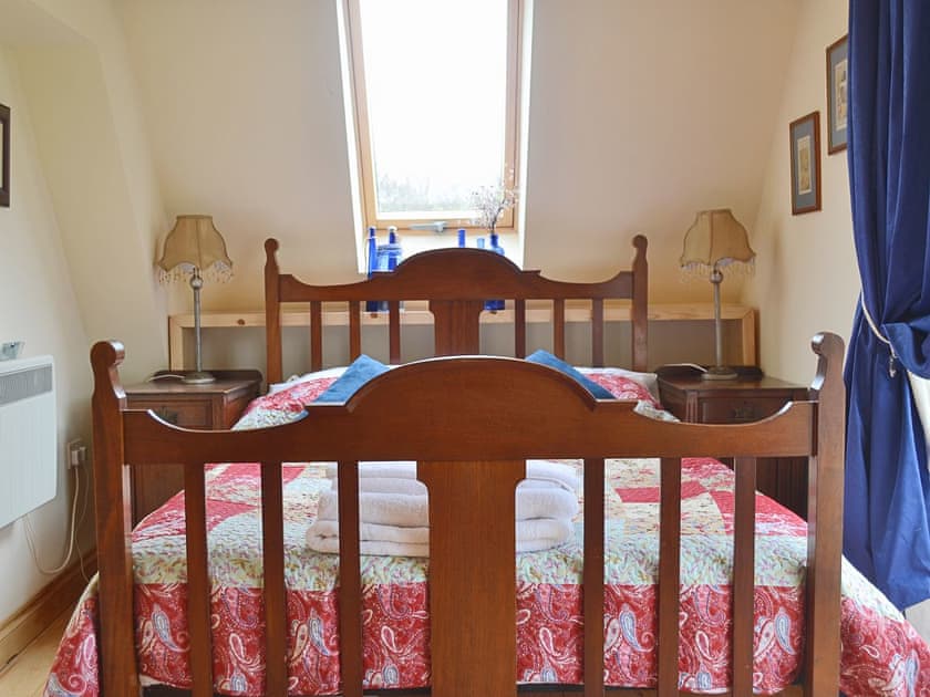 The double bedroom benefits from the skylight set into the sloping ceiling | Yr Wyddfa - The Old School, Caeathro, Caernarfon